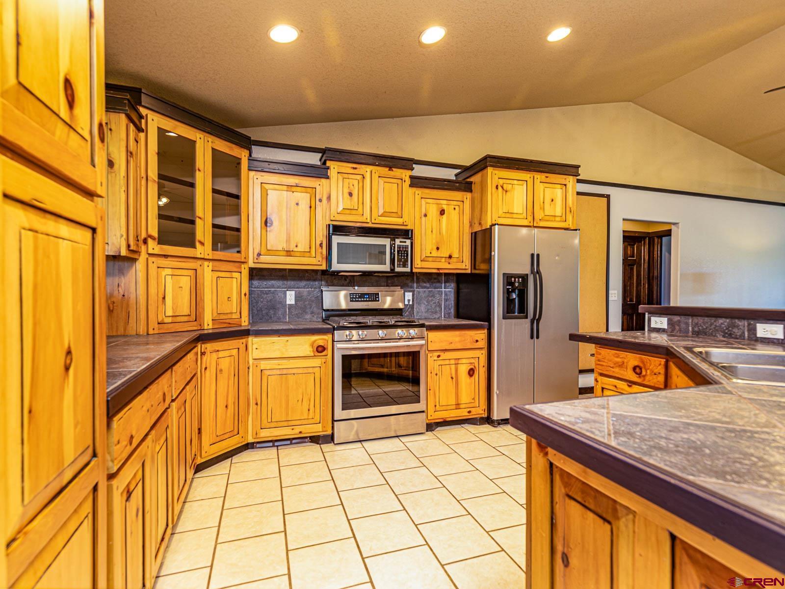 5085 3675th Road Crawford, CO 81415 - Photo 9 of 35 a kitchen with stainless steel appliances granite countertop a sink and cabinets