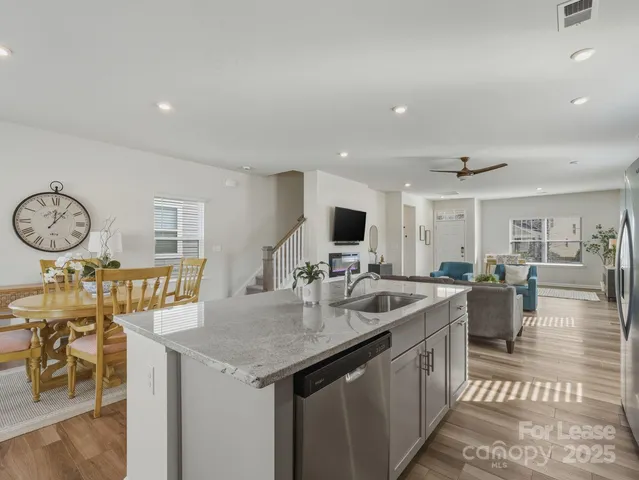 a open kitchen with stainless steel appliances granite countertop a sink and a refrigerator