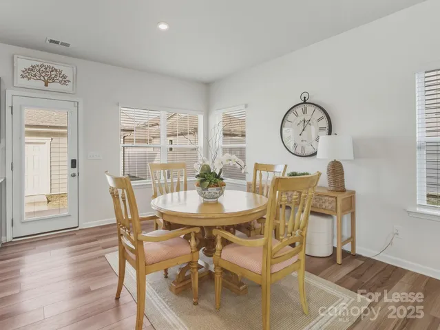a view of a dining room with furniture and a large window
