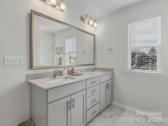 a bathroom with a granite countertop sink mirror and double