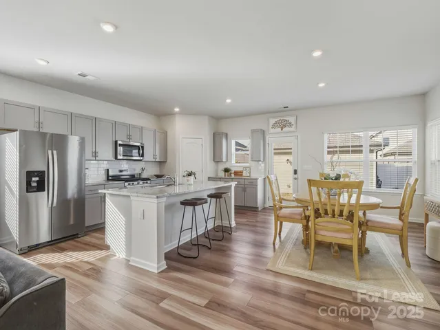 a large kitchen with a table and chairs