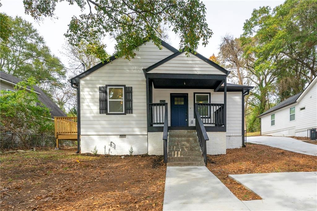 2029 Baker Road Northwest Atlanta, GA 30318 - Photo 1 of 1 a front view of a house with a porch