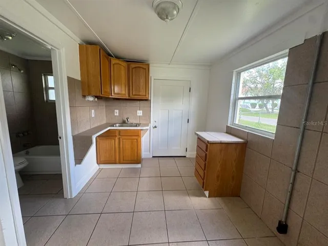 a kitchen with a sink a counter top space and cabinets