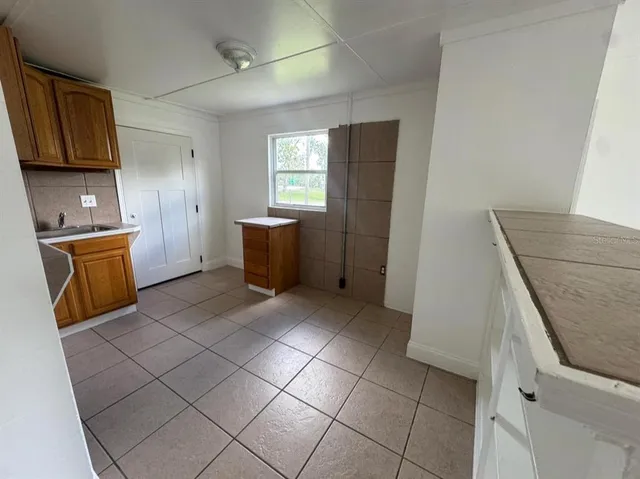 a kitchen with stainless steel appliances granite countertop a refrigerator and a stove