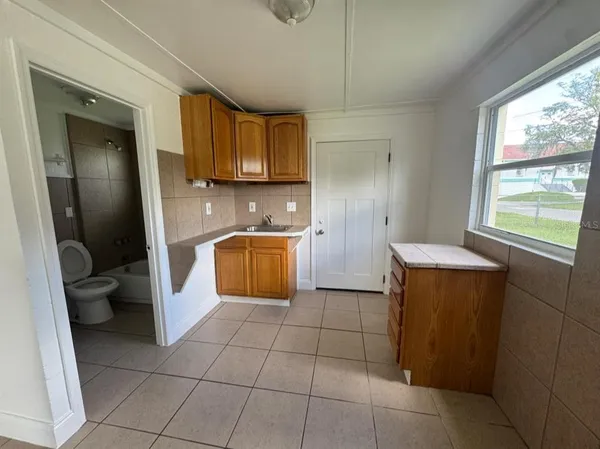 a kitchen with a sink a stove and a microwave