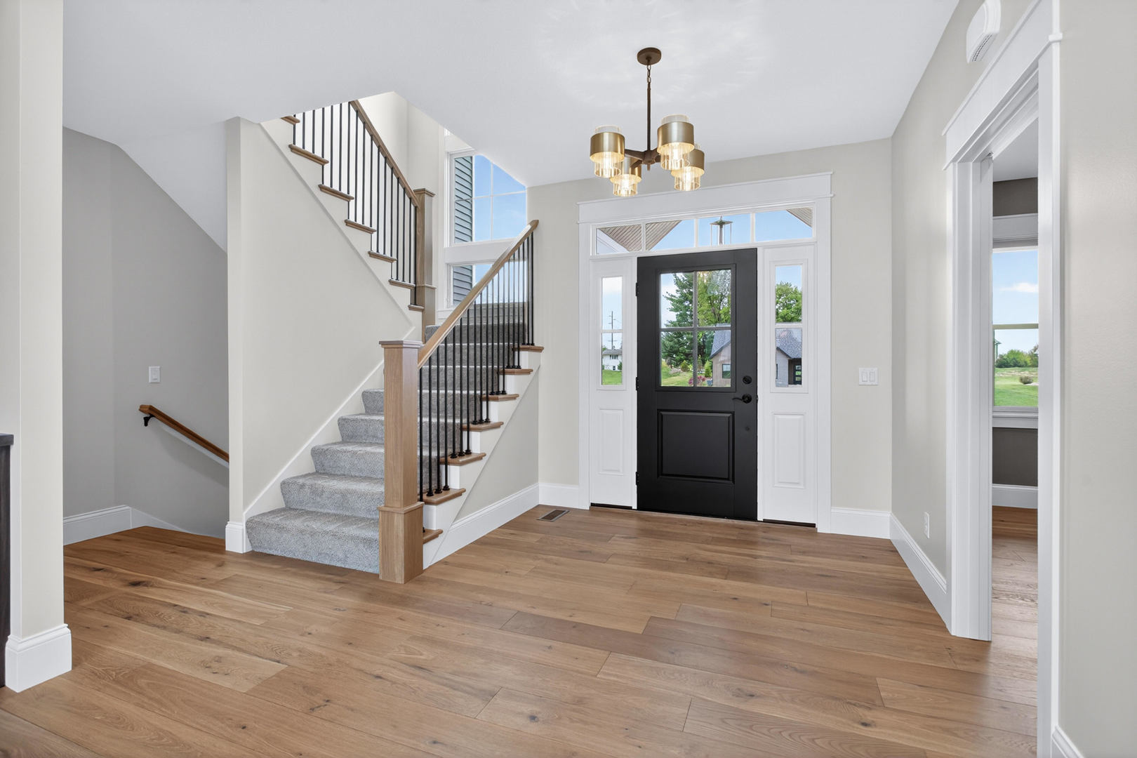 6928 Wilderness Pointe Bettendorf, IA 52722 - Photo 6 of 48 a view of a hallway with wooden floor and staircase