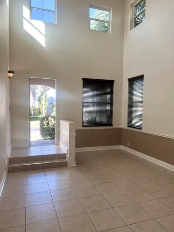 an empty room with windows and entrance