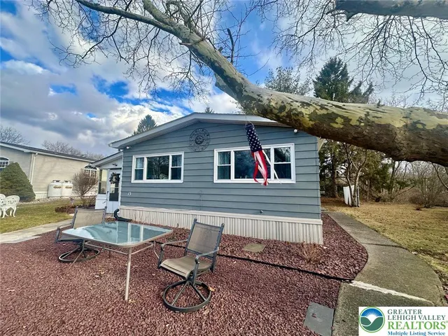 a backyard of a house with outdoor seating