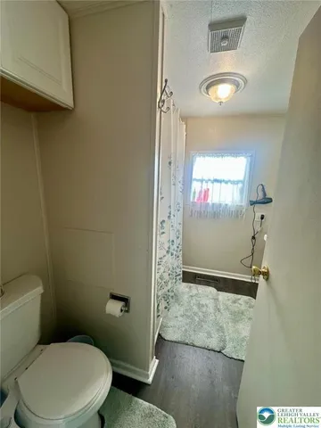 a bathroom with a toilet and a shower
