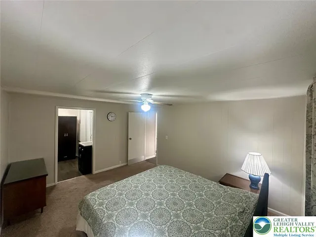 a bedroom with a bed and a lamp on table