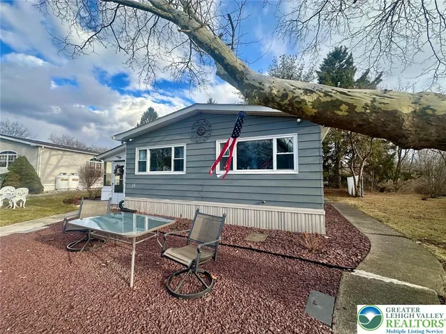 a backyard of a house with table and chairs