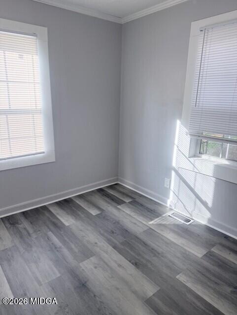 2445 Adams Avenue Macon, GA 31206 - Photo 18 of 30 an empty room with wooden floor and windows
