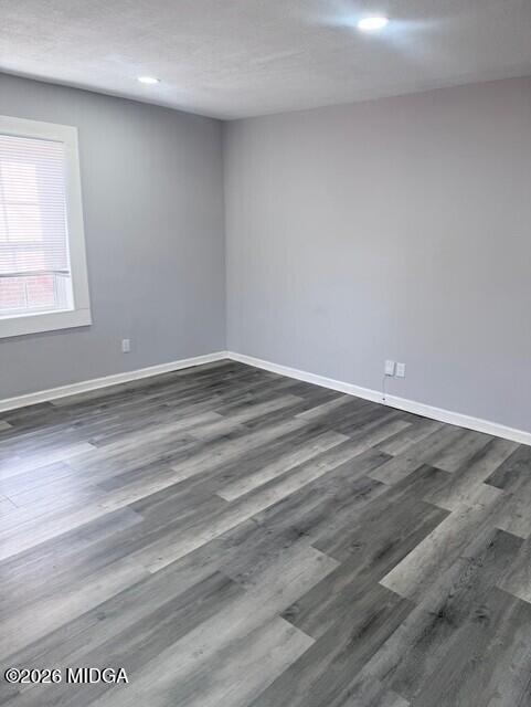 2445 Adams Avenue Macon, GA 31206 - Photo 6 of 30 a view of an empty room with wooden floor and a window
