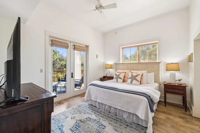 a bedroom with a bed and a flat tv screen on a dresser