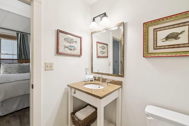 a bathroom with a sink a toilet and mirror