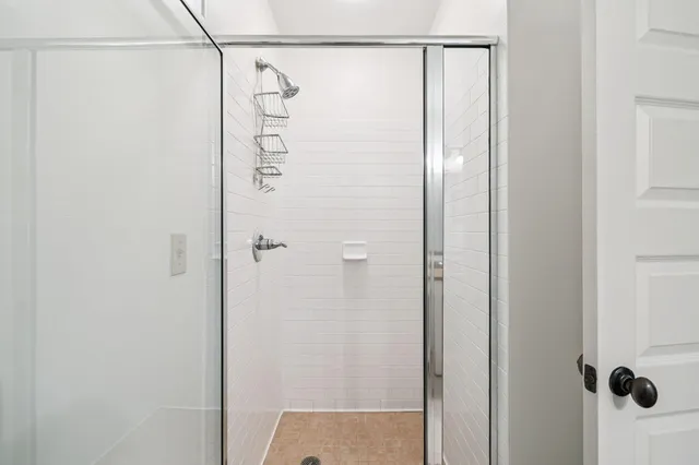 a bathroom with a glass shower door