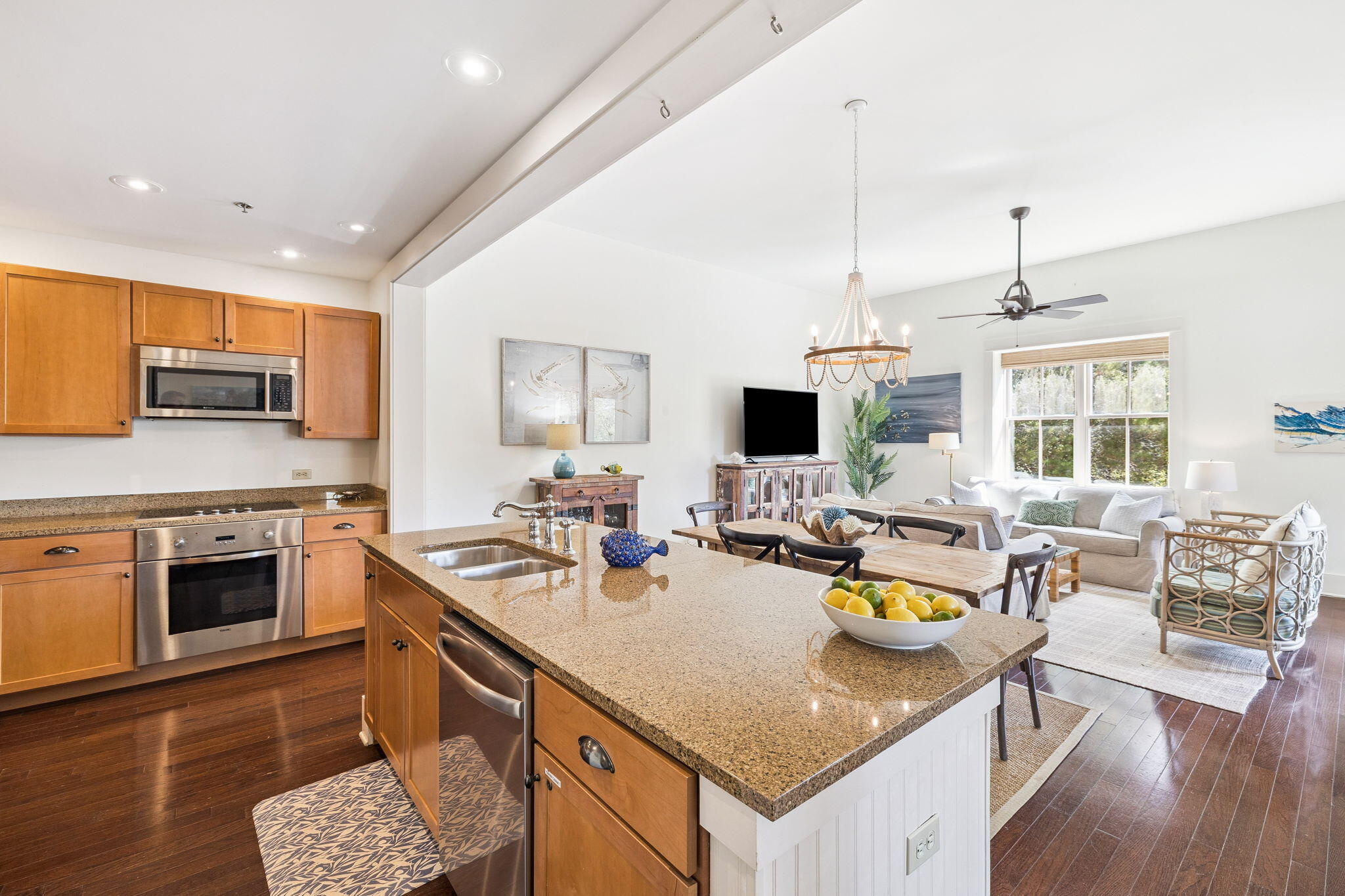 2046 West County Highway 30A, Unit M2230 Santa Rosa Beach, FL 32459 - Photo 3 of 39 a open kitchen with stainless steel appliances granite countertop a sink dishwasher a stove with a dining table and chairs with wooden floor