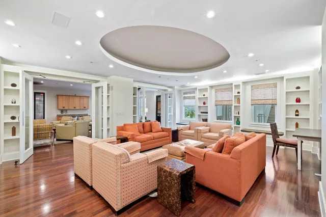 a living room with fireplace furniture and a table