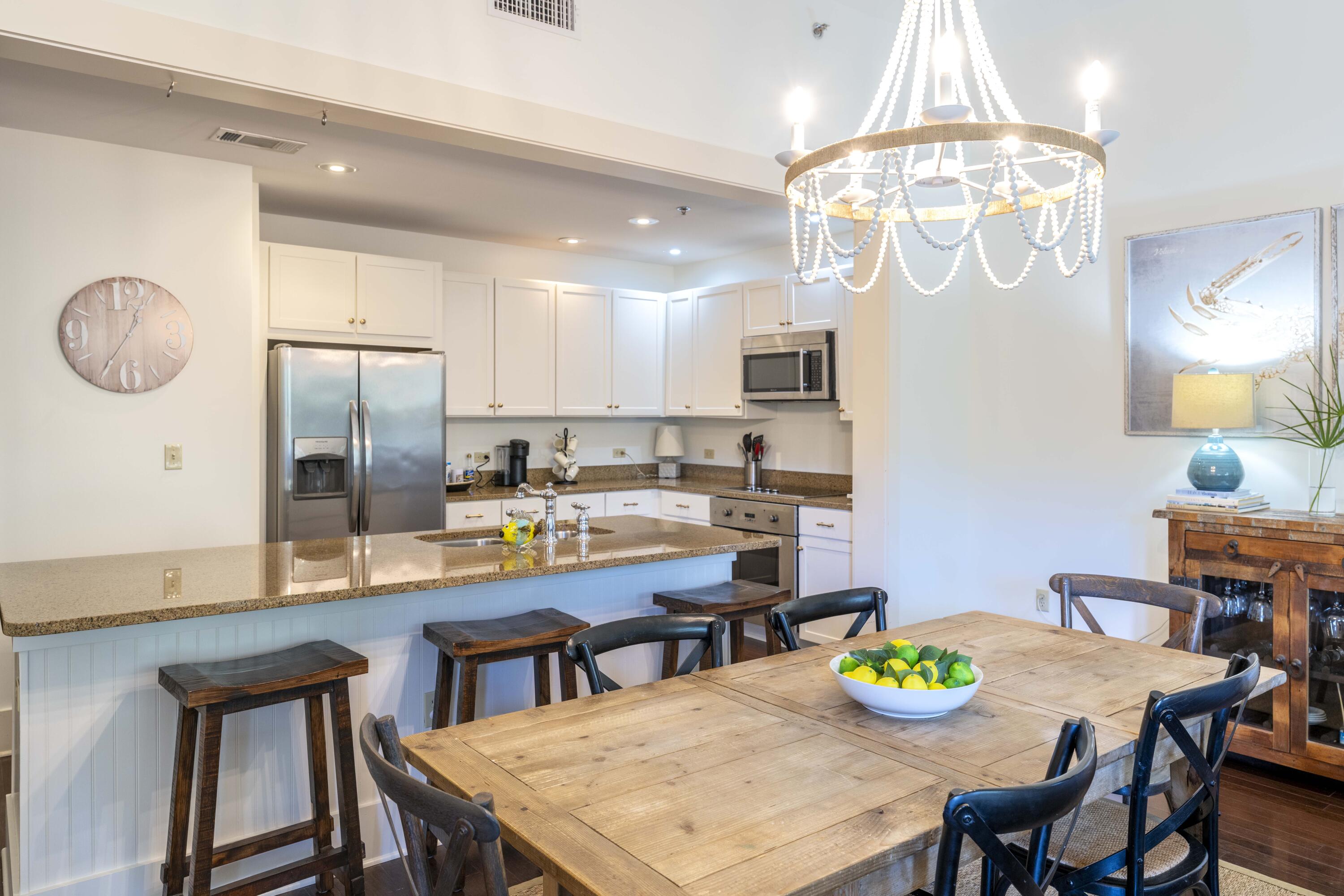 2046 West County Highway 30A, Unit M2230 Santa Rosa Beach, FL 32459 - Photo 4 of 39 a large kitchen with a table and chairs