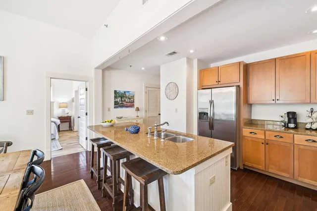 a kitchen with granite countertop a sink appliances cabinets and dining table