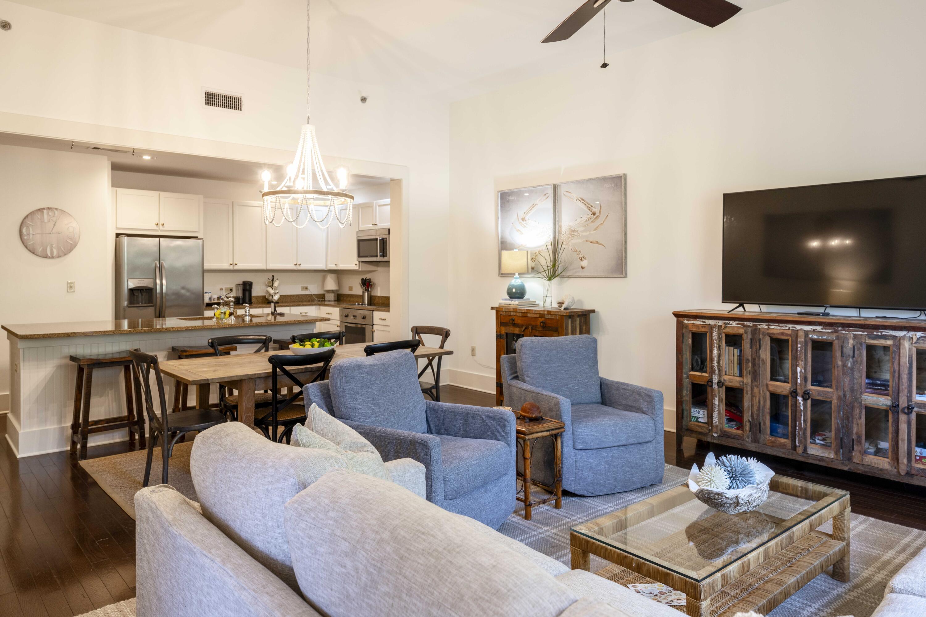 2046 West County Highway 30A, Unit M2230 Santa Rosa Beach, FL 32459 - Photo 6 of 39 a living room with furniture and a flat screen tv