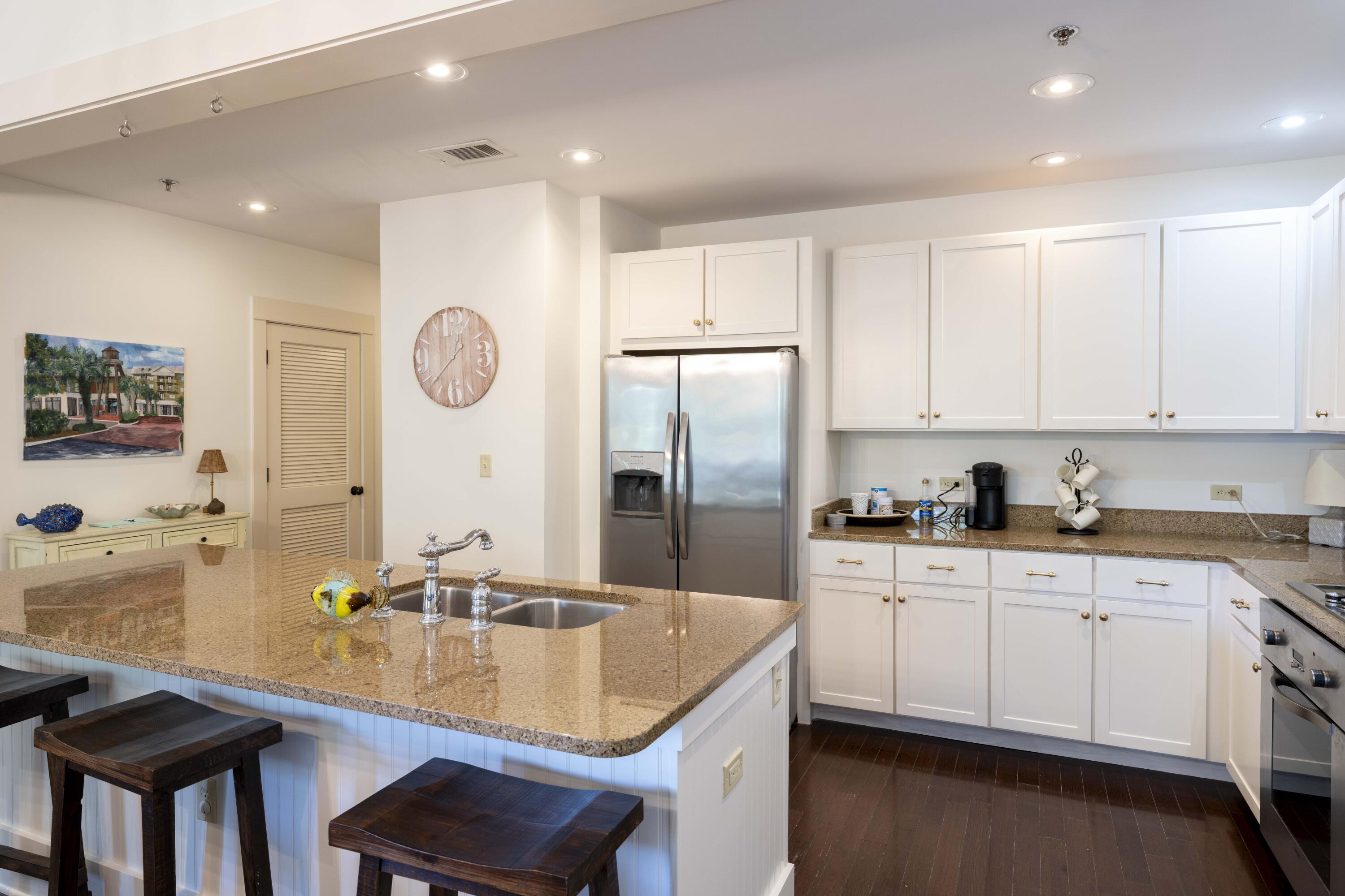 2046 West County Highway 30A, Unit M2230 Santa Rosa Beach, FL 32459 - Photo 7 of 39 a kitchen with stainless steel appliances granite countertop a sink a stove and a refrigerator