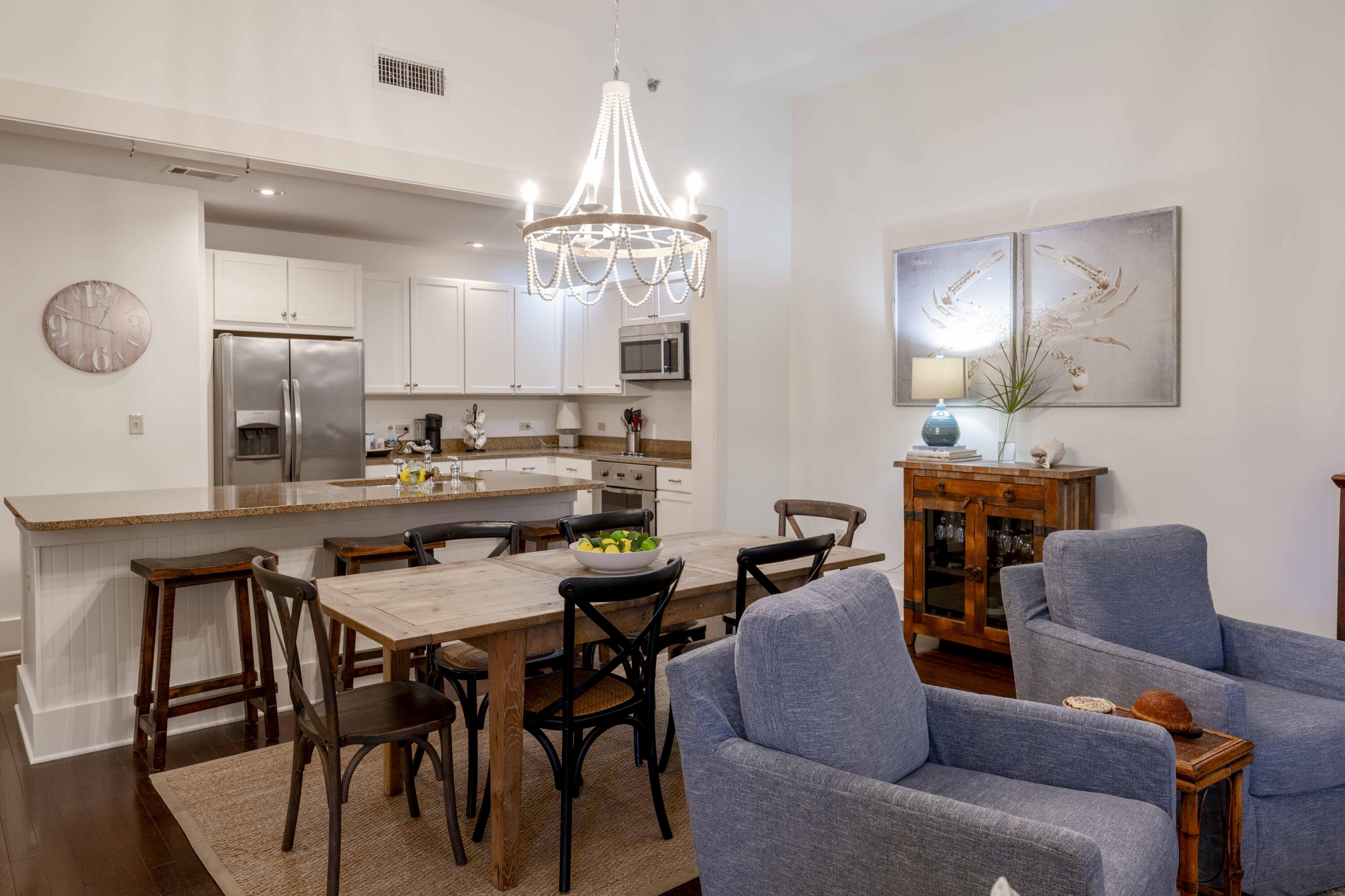 2046 West County Highway 30A, Unit M2230 Santa Rosa Beach, FL 32459 - Photo 9 of 39 a view of a dining room with furniture and chandelier