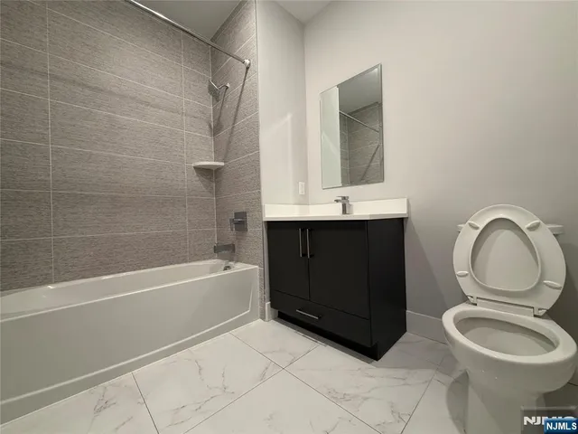 a bathroom with a toilet a sink and bathtub