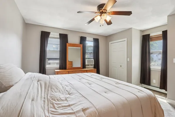 a kitchen with white cabinets and appliances