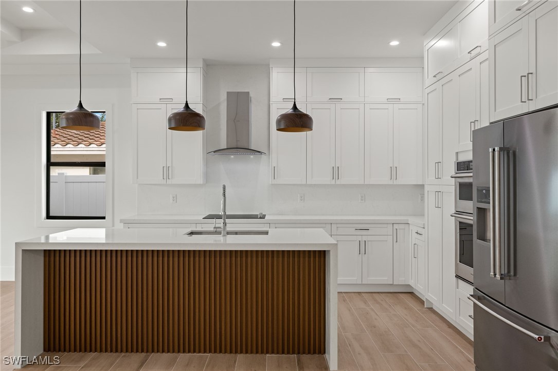 548 109th Avenue North Naples, FL 34108 - Photo 12 of 37 a kitchen with stainless steel appliances granite countertop a refrigerator a sink and a stove