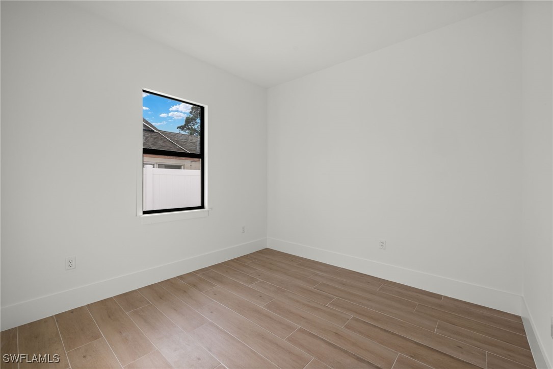 548 109th Avenue North Naples, FL 34108 - Photo 25 of 37 a view of an empty room with wooden floor and a window
