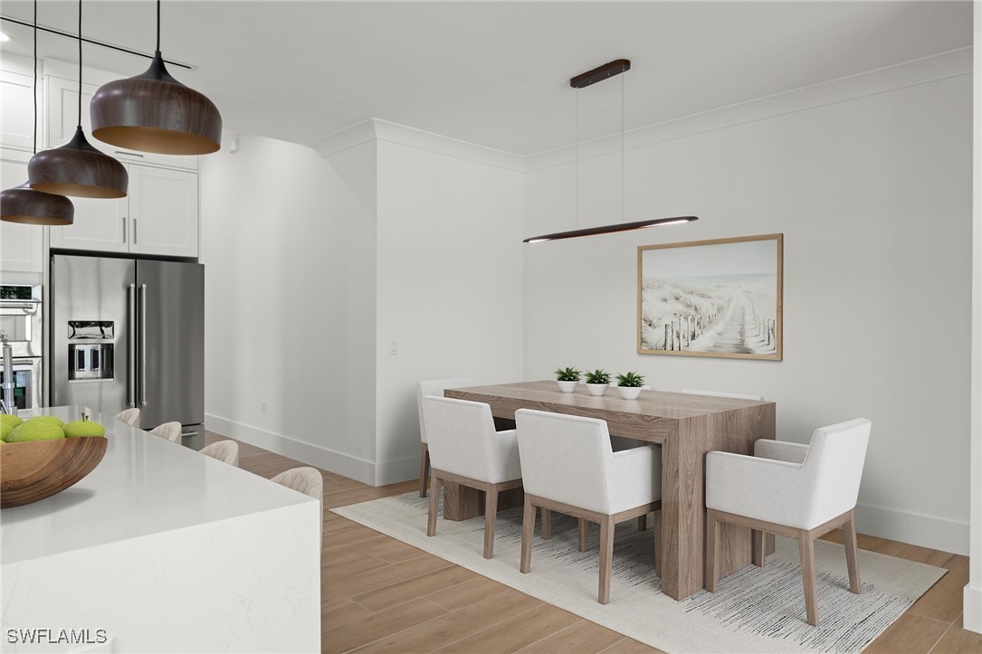 548 109th Avenue North Naples, FL 34108 - Photo 5 of 37 a view of a dining room with furniture and wooden floor