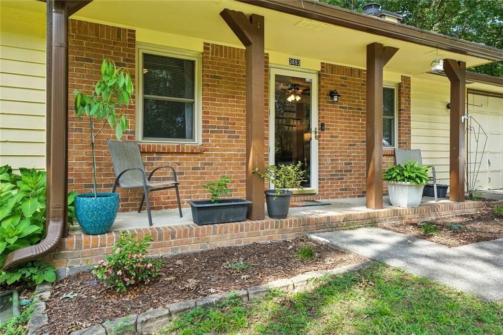 3893 Tanglewood Road Snellville, GA 30039 - Photo 1 of 1 a view of a brick house with potted plants