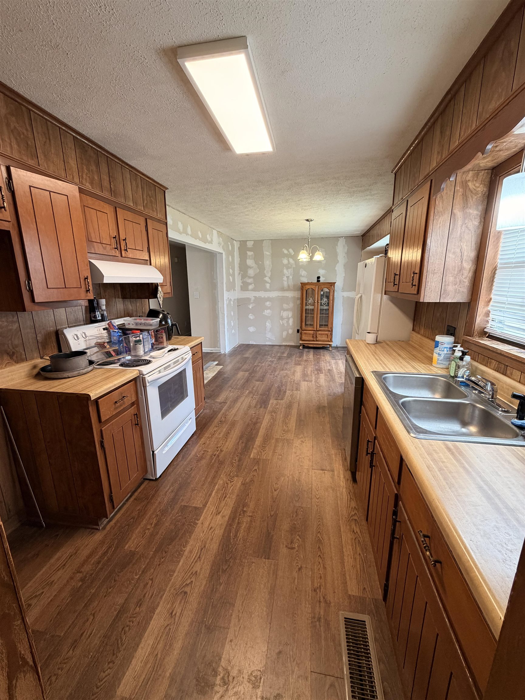 322 Robin Drive Ripley, TN 38063 - Photo 2 of 8 a kitchen with wooden floors and wooden cabinets