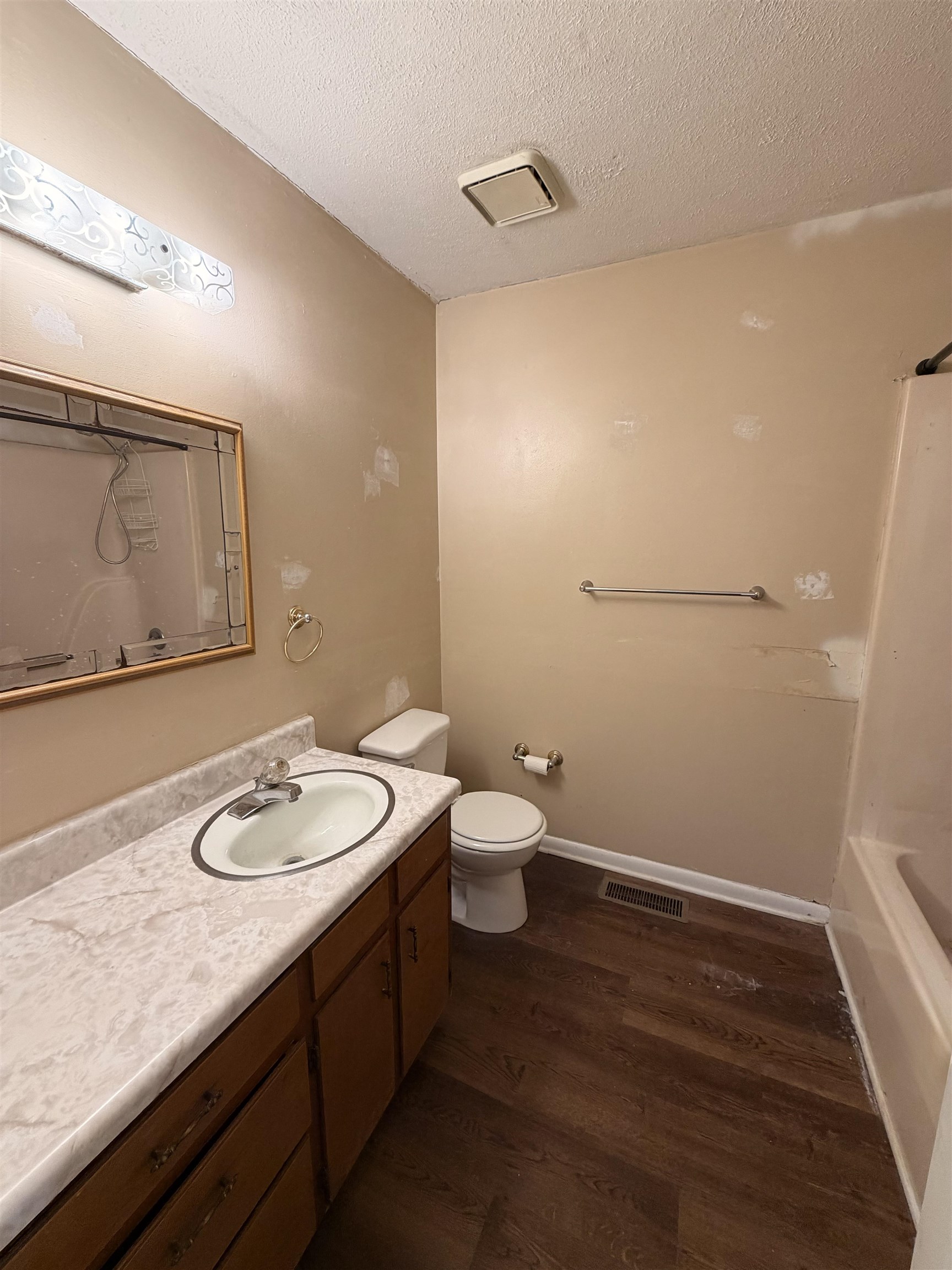 322 Robin Drive Ripley, TN 38063 - Photo 6 of 8 a bathroom with a granite countertop sink a toilet and a mirror