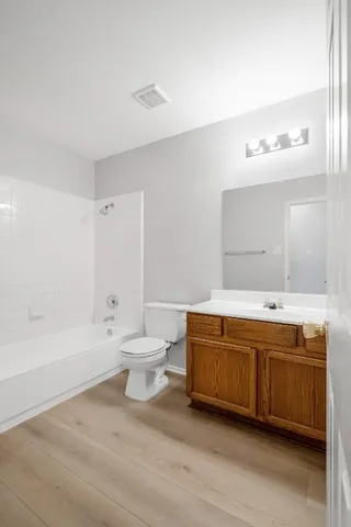 a bathroom with a tub sink and toilet