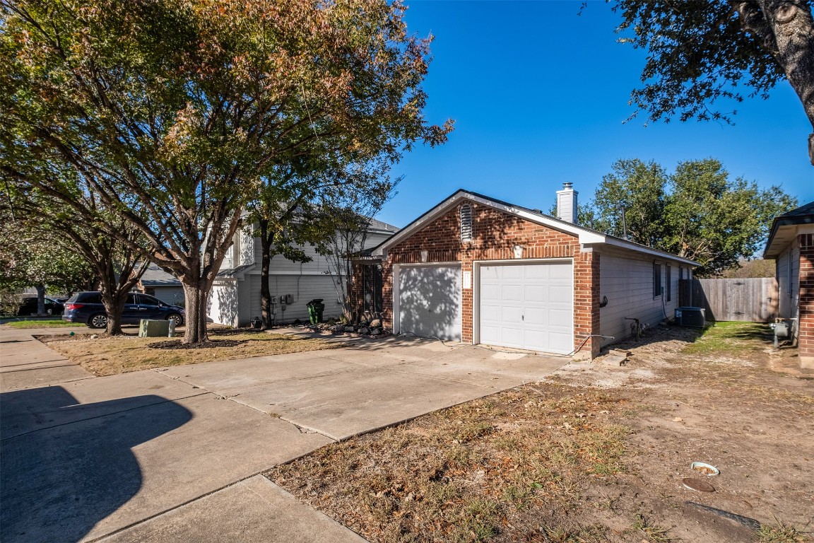 2006 Charlotte Way Round Rock, TX 78664 - Photo 23 of 24 a tall house with a large tree in front of it
