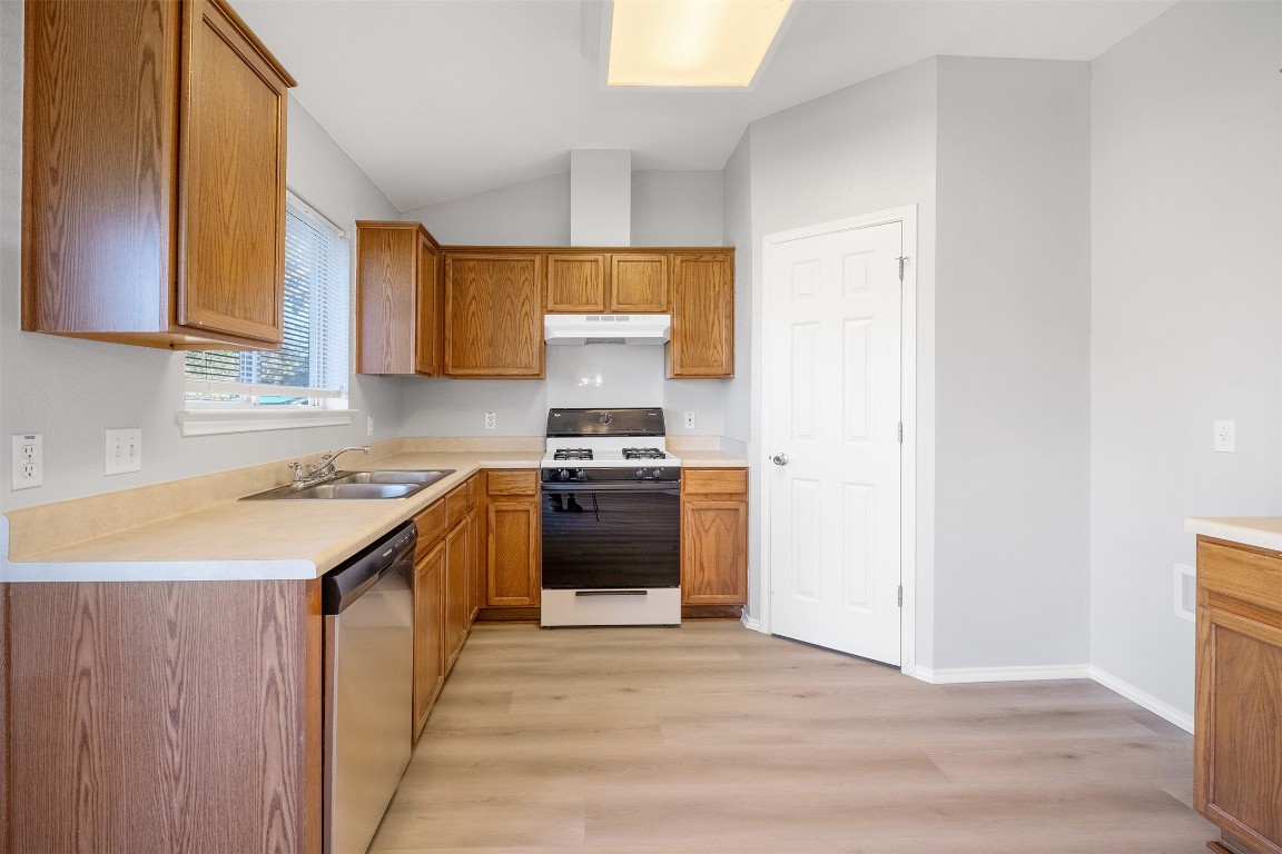 2006 Charlotte Way Round Rock, TX 78664 - Photo 5 of 24 a kitchen with stainless steel appliances granite countertop a stove a sink and a refrigerator