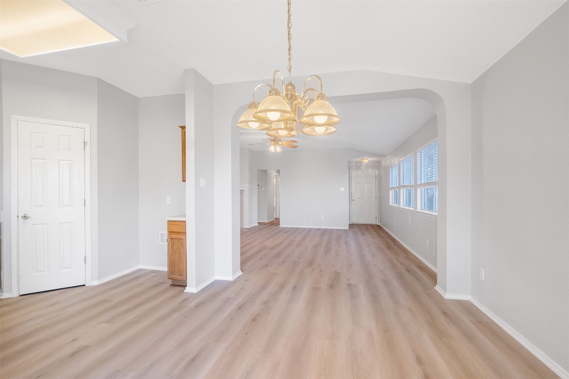 2006 Charlotte Way Round Rock, TX 78664 - Photo 7 of 24 a view of an empty room with wooden floor and a window