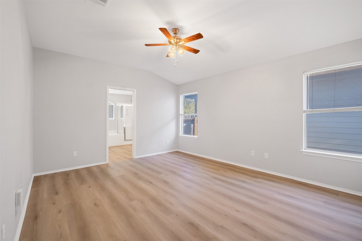 2006 Charlotte Way Round Rock, TX 78664 - Photo 8 of 24 an empty room with wooden floor and a ceiling fan