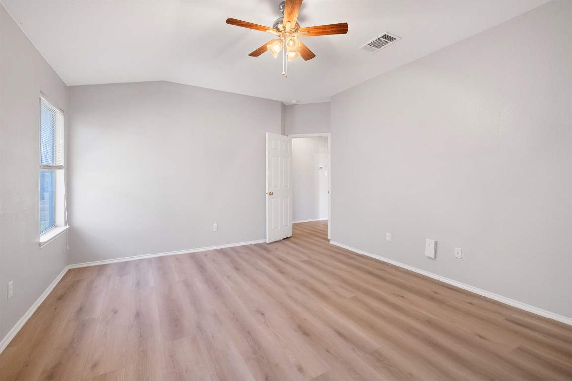 2006 Charlotte Way Round Rock, TX 78664 - Photo 9 of 24 a view of a room with wooden floor and a ceiling fan