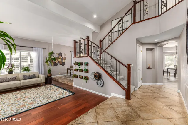 a view of a hallway with entryway wooden floor and front table