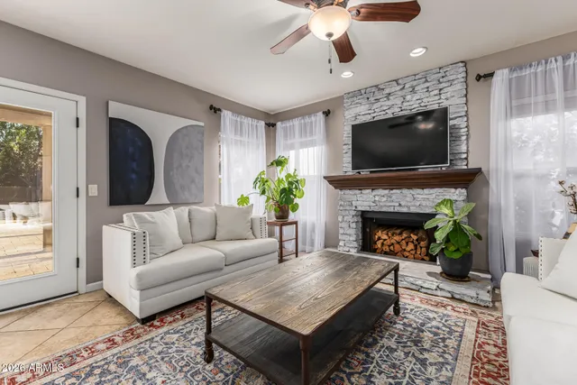 a kitchen with stainless steel appliances granite countertop a stove top oven a sink dishwasher a dining table and chairs with wooden floor