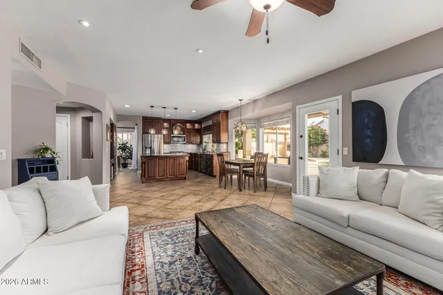 a kitchen with stainless steel appliances granite countertop a refrigerator a stove and a sink