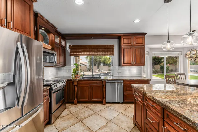 a view of a dining room with furniture and a chandelier fan