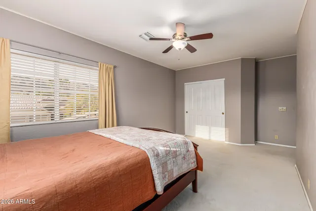 a front view of a house with garden and sitting area