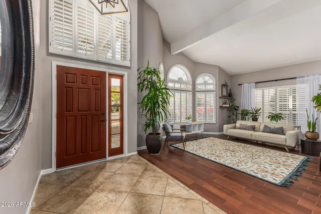 a living room with furniture fireplace and a large window
