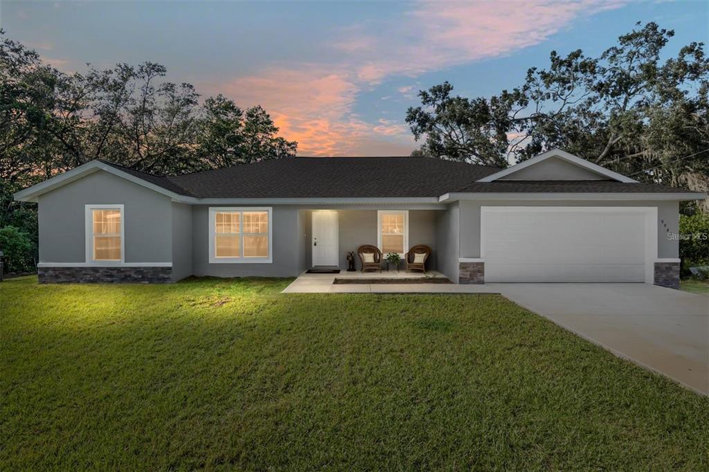 9947 Southeast 117th Street Road Belleview, FL 34420 - Photo 2 of 44 a view of a house with backyard and garden
