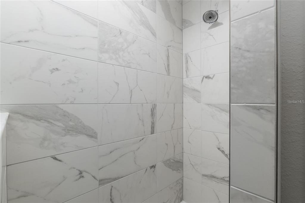 9947 Southeast 117th Street Road Belleview, FL 34420 - Photo 26 of 44 a bathroom with a shower