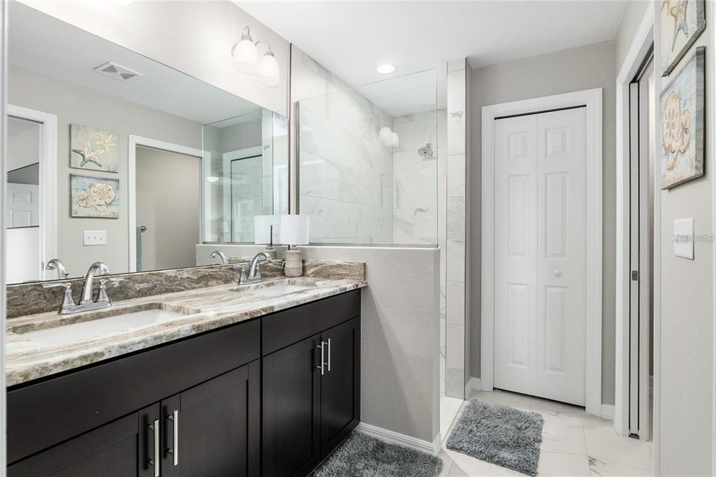 9947 Southeast 117th Street Road Belleview, FL 34420 - Photo 28 of 44 a bathroom with a granite countertop sink and a mirror
